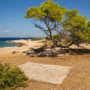 Sea shore and sandy beach of the island  Moni, Saronida, Greece