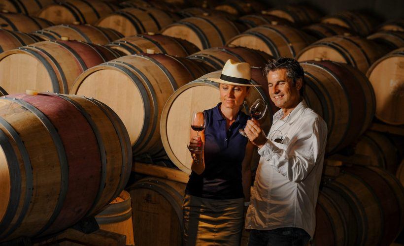 Tourism – Couple tasting wine in a cellar